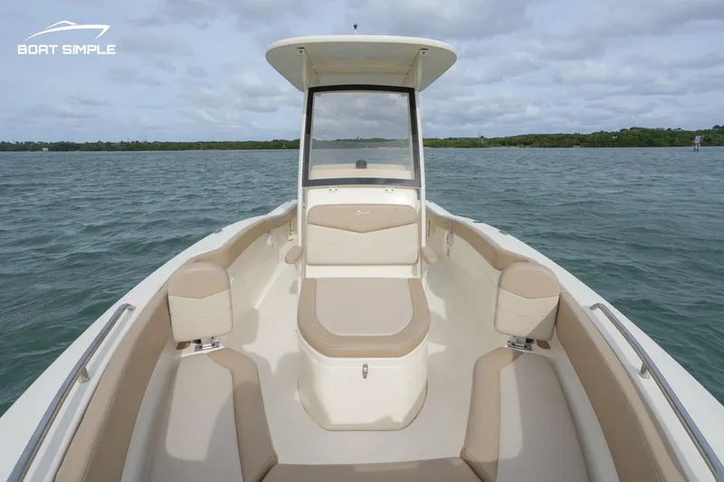 Slide: The Image of 2023 Scout 215 XSF boat interior with beige seating on open water. - 5