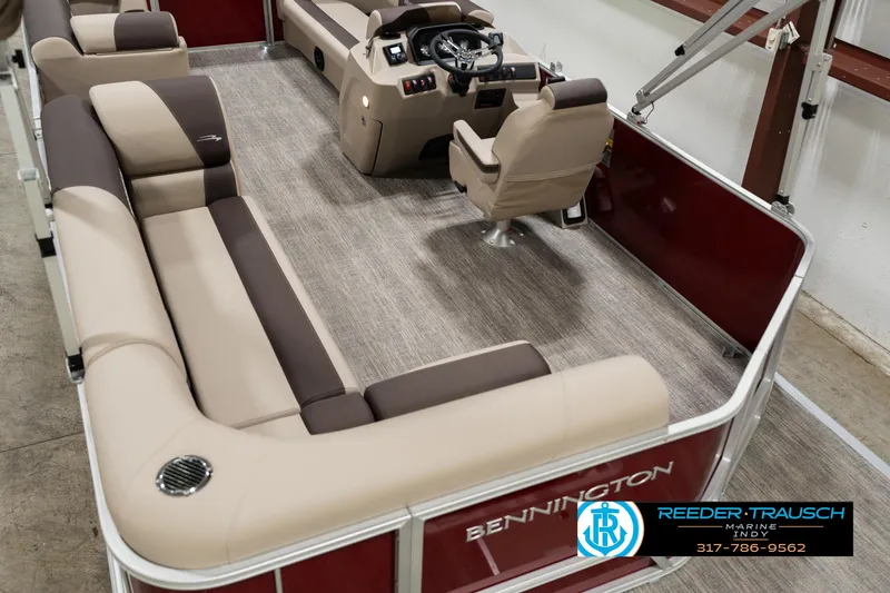 Slide: The Image of 2025 Bennington 21 SLSE pontoon boat interior with beige seating and modern helm. - 10
