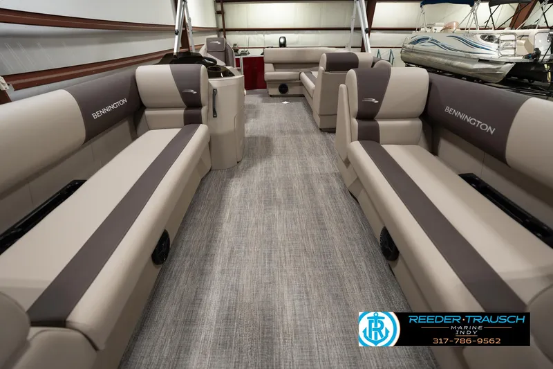 Slide: The Image of 2025 Bennington 21 SLSE pontoon boat interior with beige seating and gray flooring. - 12