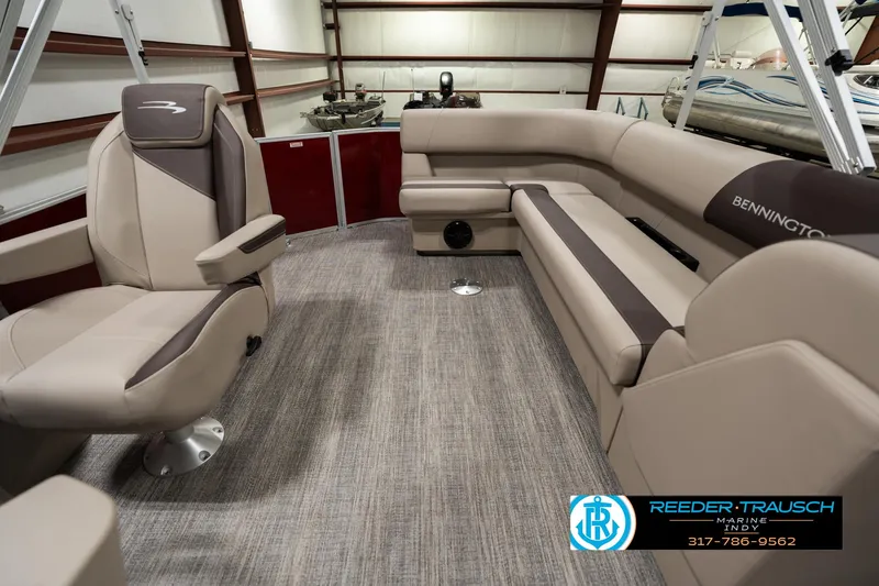 Slide: The Image of 2025 Bennington 21 SLSE pontoon boat interior with plush seating and modern design. - 13