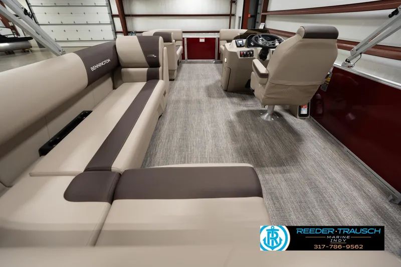 Slide: The Image of 2025 Bennington 21 SLSE pontoon boat interior with beige seating and modern helm. - 15