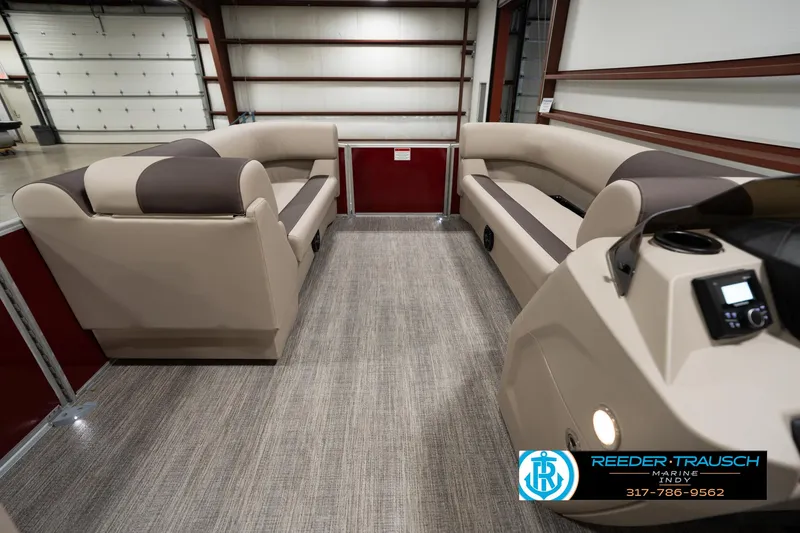 Slide: The Image of 2025 Bennington 21 SLSE pontoon boat interior with beige seating and modern design. - 16