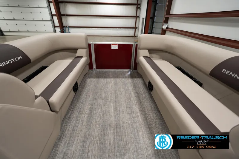 Slide: The Image of 2025 Bennington 21 SLSE pontoon boat interior with beige seating and carpeted floor. - 17