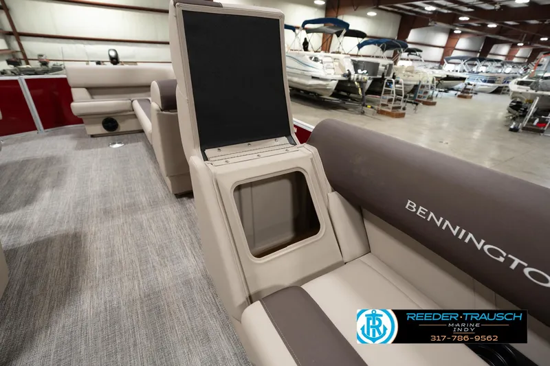 Slide: The Image of 2025 Bennington 21 SLSE pontoon boat interior with storage compartment open in showroom. - 20