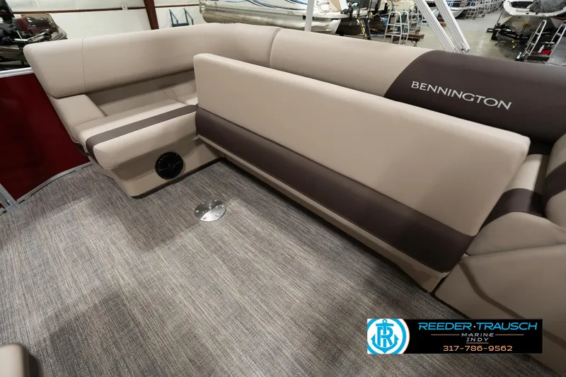 Slide: The Image of 2025 Bennington 21 SLSE pontoon boat interior with beige seating and carpeted flooring. - 22
