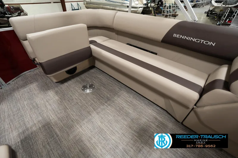 Slide: The Image of 2025 Bennington 21 SLSE pontoon boat interior with beige seating and carpeted flooring. - 23