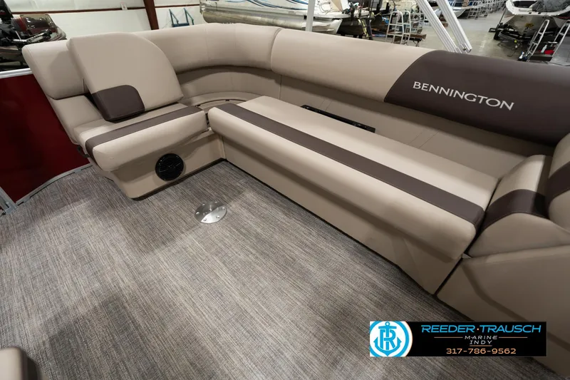 Slide: The Image of 2025 Bennington 21 SLSE pontoon boat interior with beige seating and carpet flooring. - 24