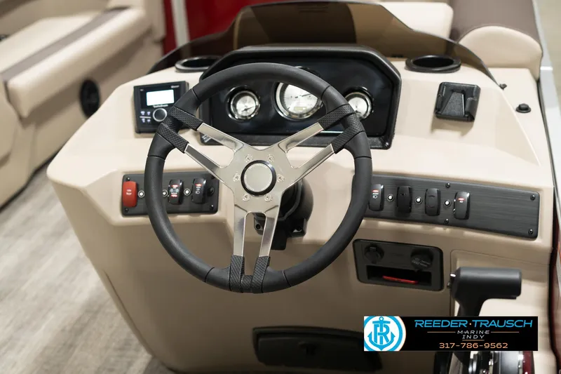 Slide: The Image of 2025 Bennington 21 SLSE boat dashboard with steering wheel and controls. - 25