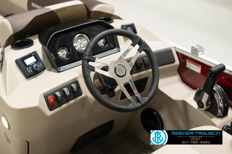 Slide: The Image of 2025 Bennington 21 SLSE boat dashboard with steering wheel and control panel. - 26