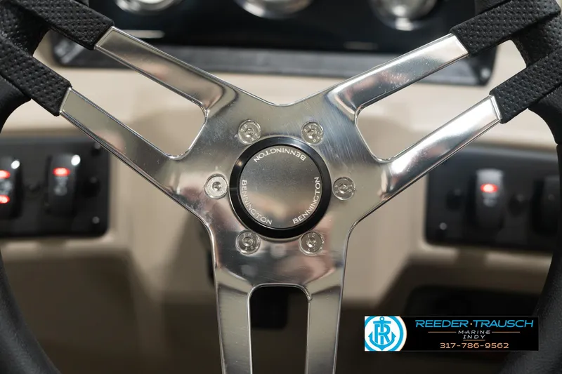 Slide: The Image of 2025 Bennington 21 SLSE steering wheel with chrome accents and control panel. - 27