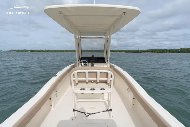 Slide: The Image of 2023 Scout 215 XSF boat on open water, featuring a sleek design and spacious deck. - 4