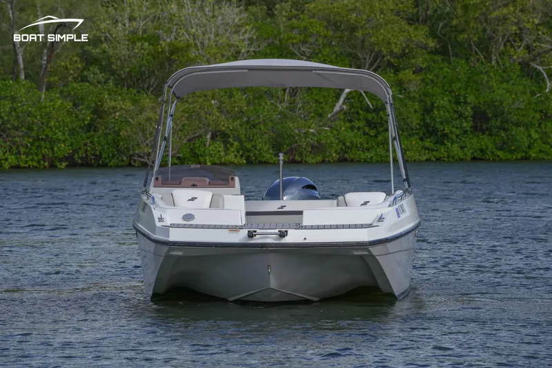 Slide: The Image of 2023 Starcraft SVX 191 OB boat on water, surrounded by lush greenery. - 3