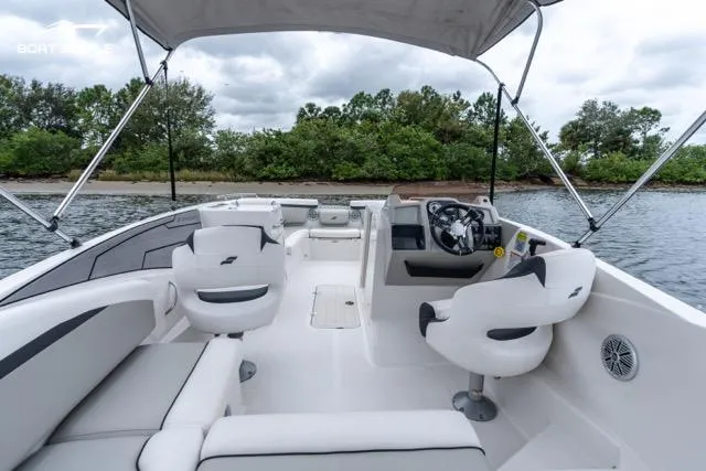 Slide: The Image of 2023 Starcraft SVX 231 OB DH boat interior with seating and steering wheel. - 6