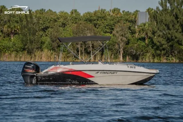 Slide: The Image of 2022 Starcraft SVX 171 OB boat on a lake with lush greenery background. - 1