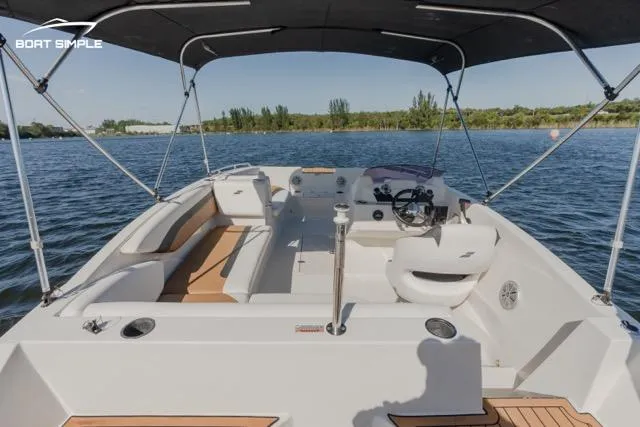 Slide: The Image of 2022 Starcraft SVX 171 OB boat with canopy on a serene lake. - 9