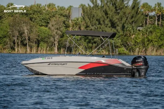 Slide: The Image of 2022 Starcraft SVX 171 OB boat on a lake with trees in the background. - 0