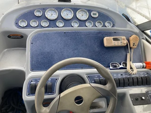 Slide: The Image of Dashboard of a 2004 Bayliner 3055 Ciera boat with gauges and radio. - 16