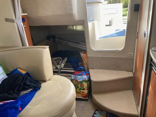 Slide: The Image of Interior of 2004 Bayliner 3055 Ciera boat with seating and storage area. - 7