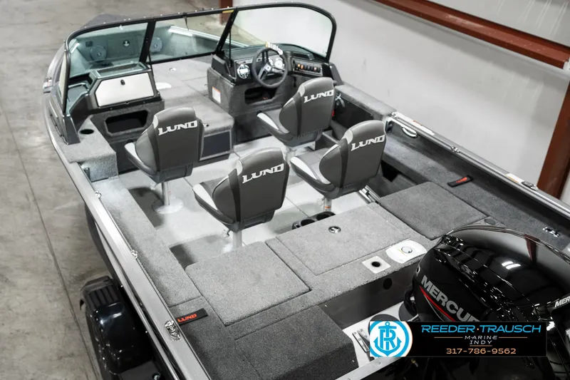 Slide: The Image of 2025 Lund 1775 Impact XS boat interior with four seats and Mercury engine. - 11
