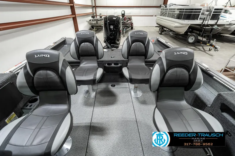Slide: The Image of 2025 Lund 1775 Impact XS boat interior with four seats in a showroom. - 14
