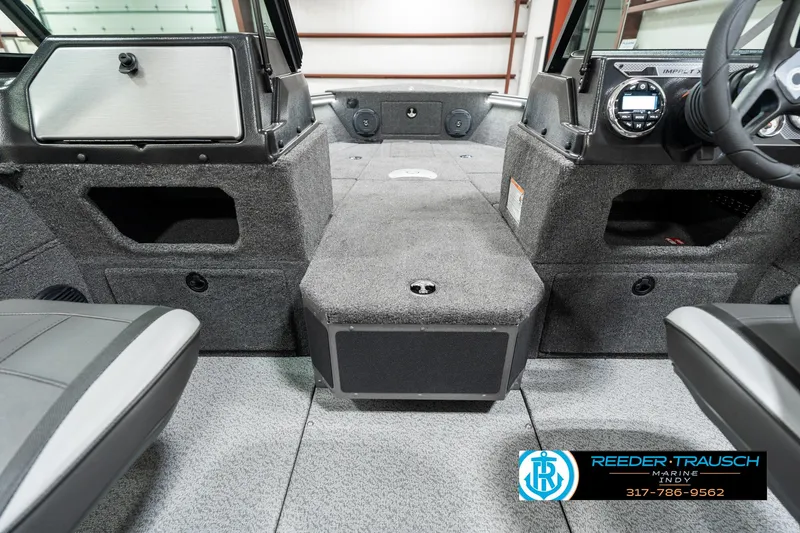 Slide: The Image of Interior of 2025 Lund 1775 Impact XS boat, featuring seating and dashboard controls. - 21