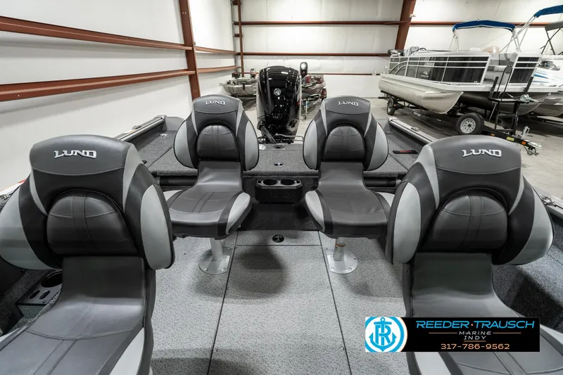 Slide: The Image of 2025 Lund 1775 Impact XS boat interior with four seats in a showroom. - 23