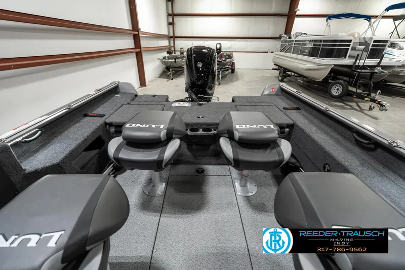 Slide: The Image of 2025 Lund 1775 Impact XS boat interior with seating in a showroom. - 24