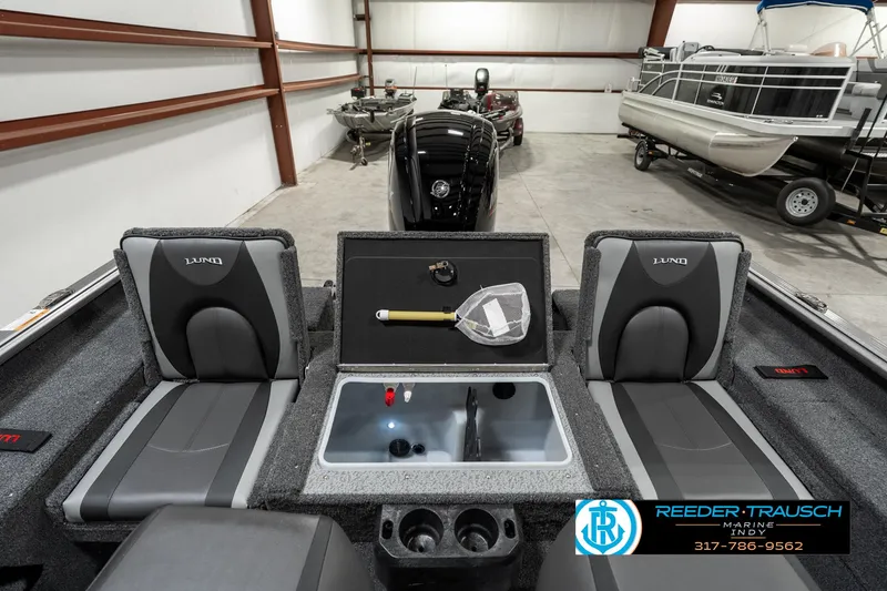 Slide: The Image of 2025 Lund 1775 Impact XS boat interior with fishing gear in a showroom. - 27