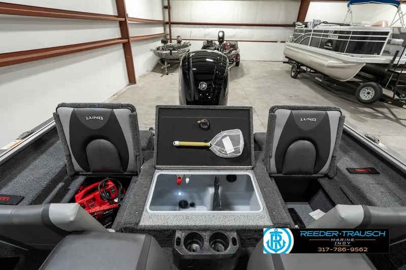 Slide: The Image of 2025 Lund 1775 Impact XS boat interior with fishing gear and storage compartments. - 28