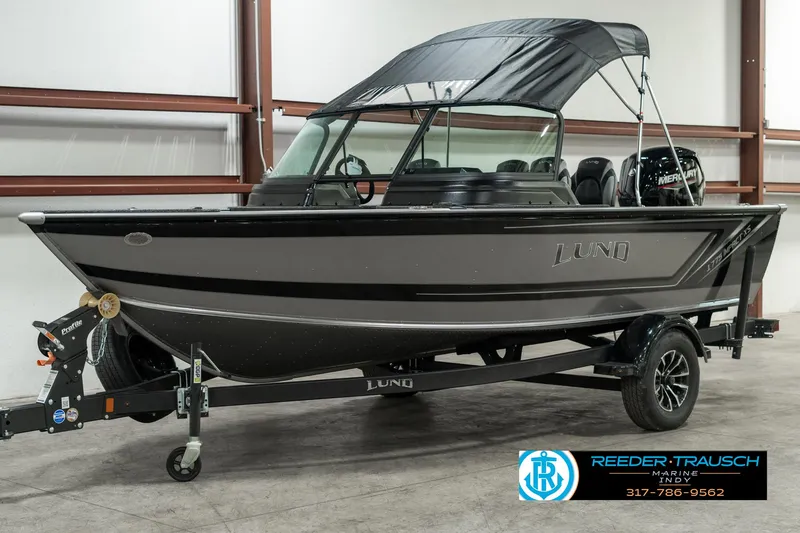 Slide: The Image of 2025 Lund 1775 Impact XS boat with canopy on trailer in showroom. - 3