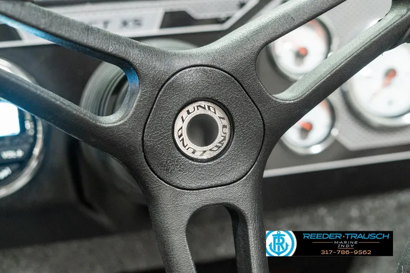 Slide: The Image of 2025 Lund 1775 Impact XS steering wheel and dashboard close-up. - 31