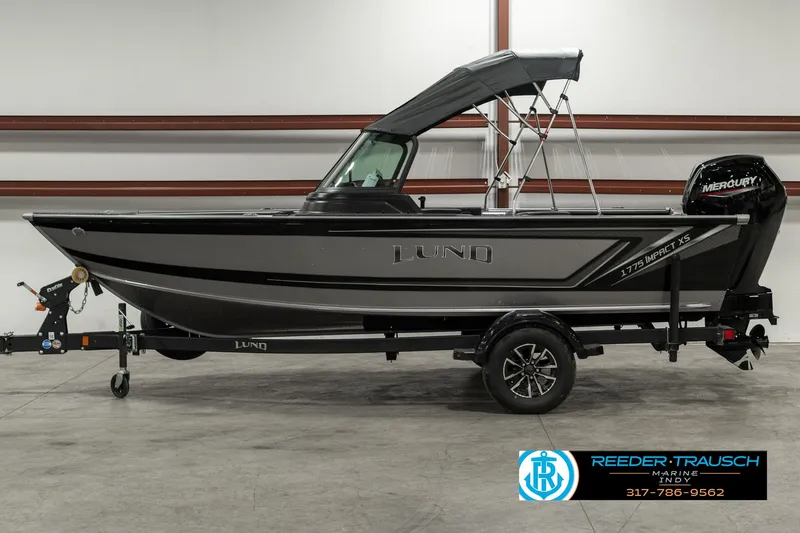 Slide: The Image of 2025 Lund 1775 Impact XS boat with trailer in showroom. - 4