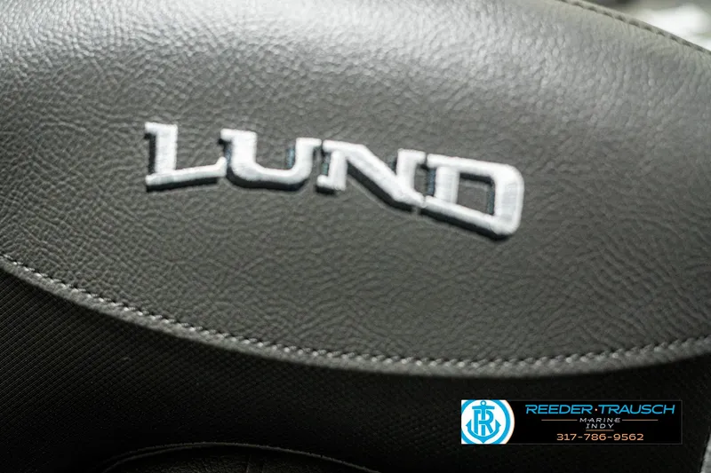 Slide: The Image of Close-up of 2025 Lund 1775 Impact XS logo on black leather surface. - 40