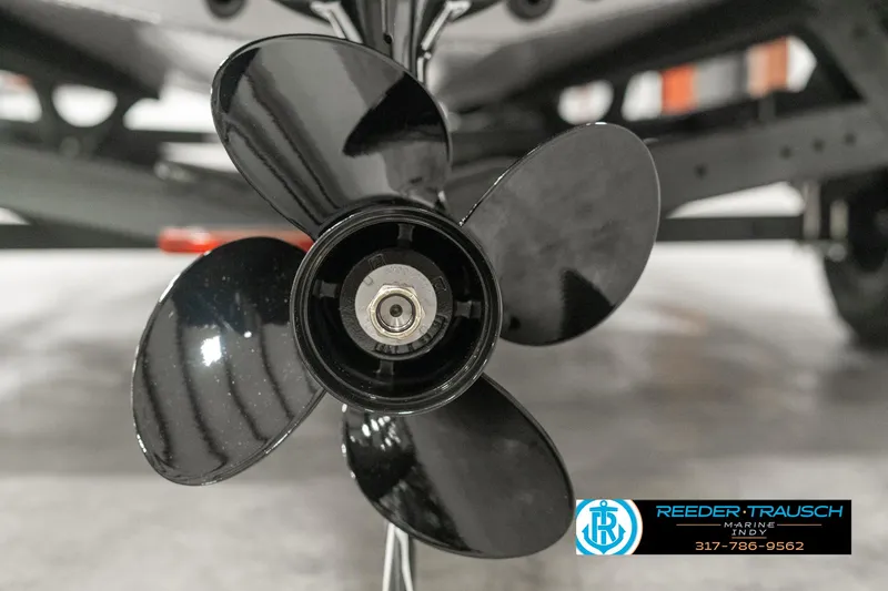 Slide: The Image of 2025 Lund 1775 Impact XS boat propeller close-up, black blades, Reeder-Trausch logo visible. - 45