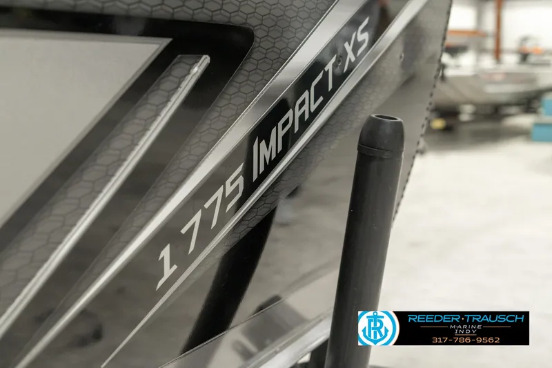 Slide: The Image of Close-up of 2025 Lund 1775 Impact XS boat model logo. - 47