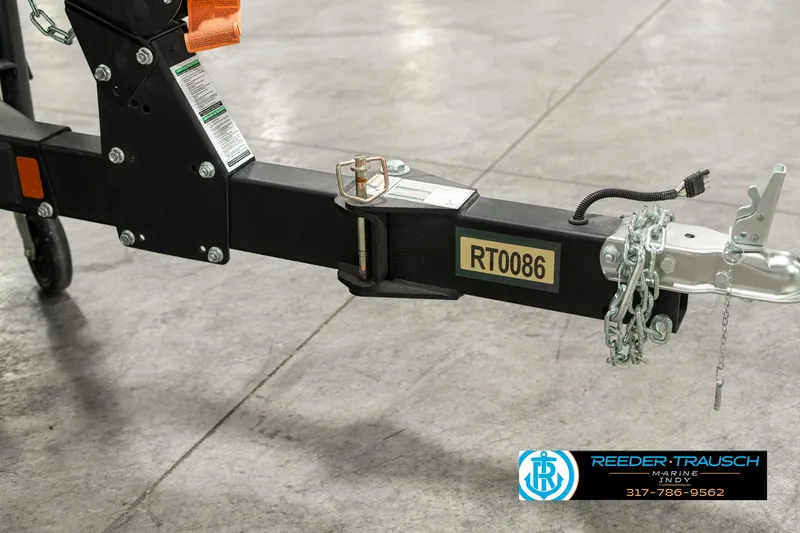 Slide: The Image of 2025 Lund 1775 Impact XS trailer hitch with safety chain and lock mechanism. - 48