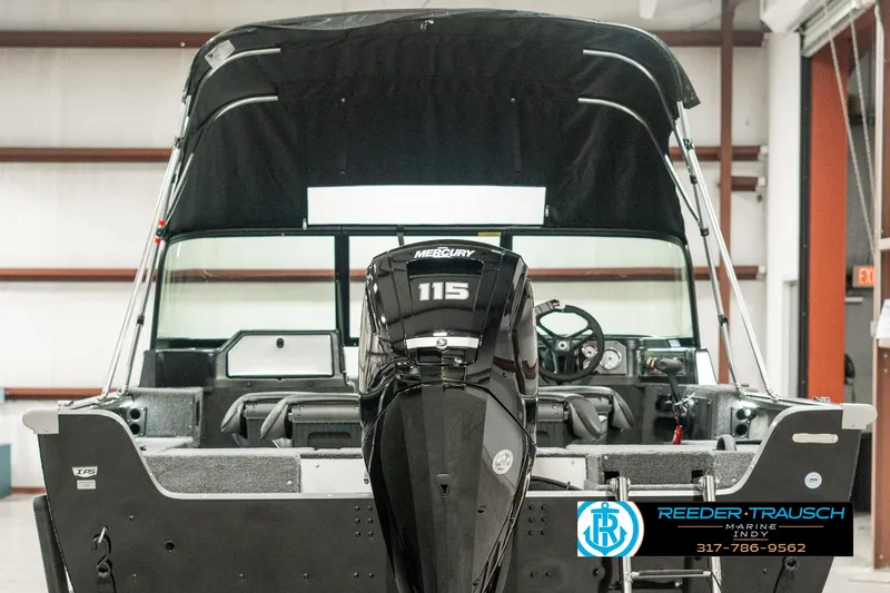 Slide: The Image of 2025 Lund 1775 Impact XS boat with Mercury 115 engine in showroom. - 6