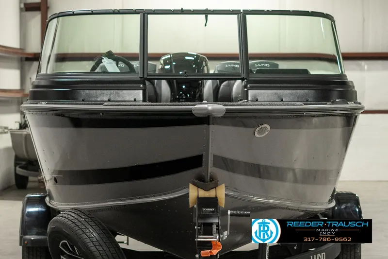 Slide: The Image of 2025 Lund 1775 Impact XS boat in showroom, front view, on trailer. - 7