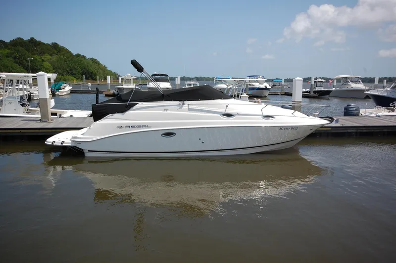 The Image of 2007 Regal 2665 Commodore boat docked at marina, calm water, clear sky. - 0