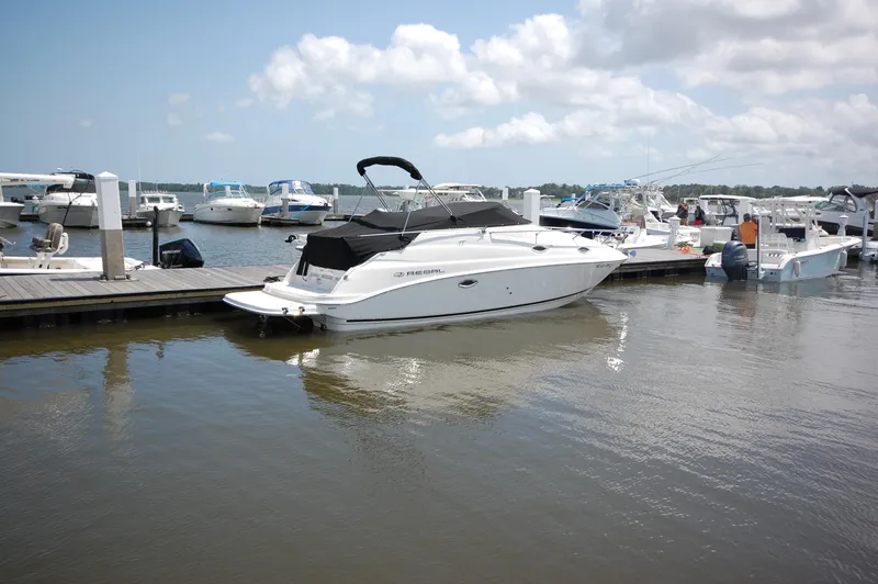 Slide: The Image of 2007 Regal 2665 Commodore boat docked at marina under cloudy sky. - 1