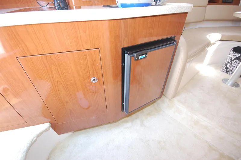 Slide: The Image of 2007 Regal 2665 Commodore interior with wood cabinetry and compact refrigerator. - 12