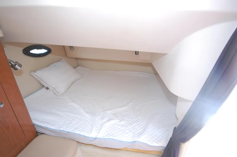 Slide: The Image of 2007 Regal 2665 Commodore cabin with cozy bed and porthole window. - 14
