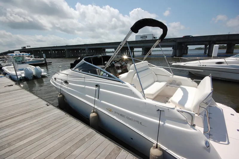 Slide: The Image of 2007 Regal 2665 Commodore boat docked near a bridge on a sunny day. - 2