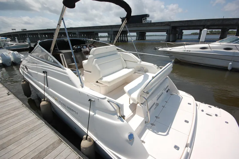 Slide: The Image of 2007 Regal 2665 Commodore boat docked by a bridge on a sunny day. - 4