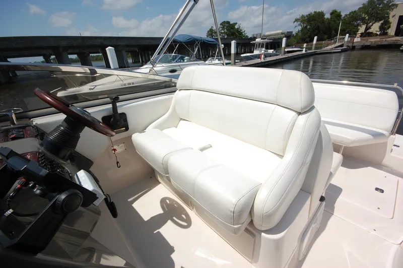 Slide: The Image of 2007 Regal 2665 Commodore boat interior with white seating and steering wheel. - 8