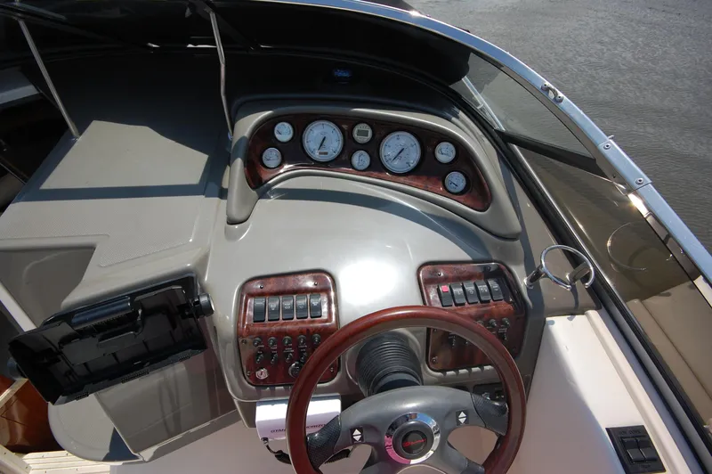 Slide: The Image of 2007 Regal 2665 Commodore boat dashboard with gauges and controls. - 9