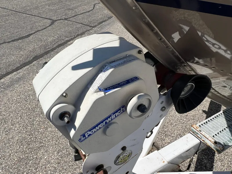 Slide: The Image of Powerwinch on 2001 Alumacraft Trophy 175 boat trailer, parked on asphalt. - 15