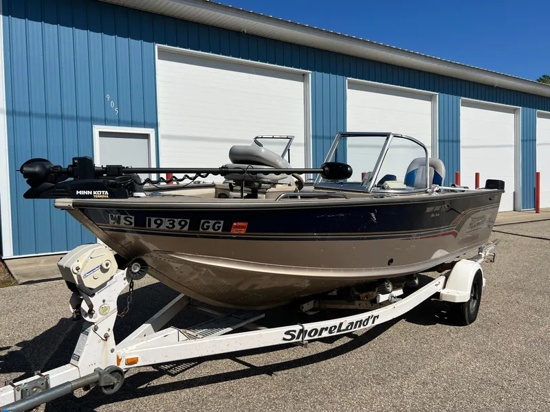 Slide: The Image of 2001 Alumacraft Trophy 175 boat on ShoreLand'r trailer, parked outside blue storage units. - 20