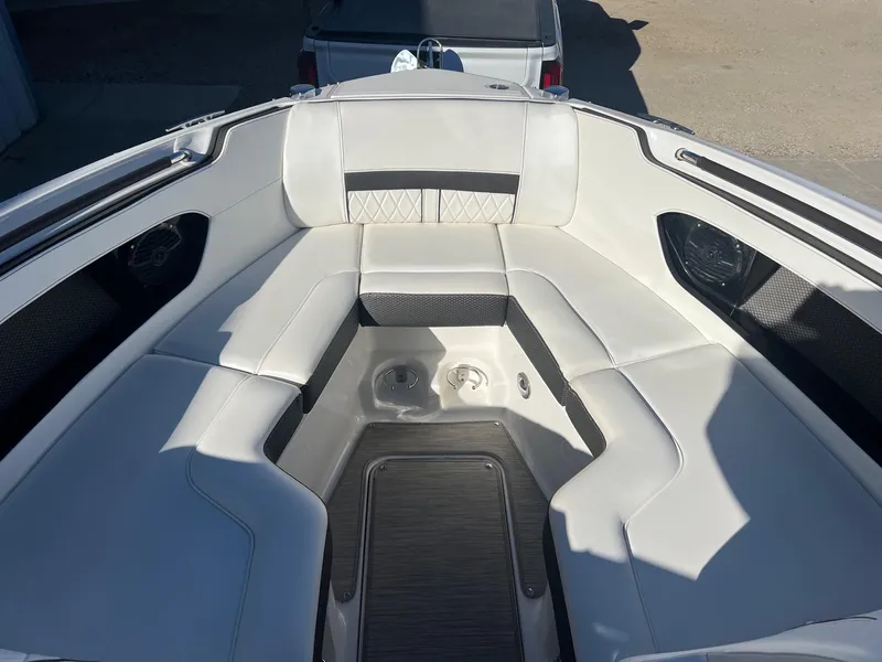 Slide: The Image of 2018 Sea Ray 280 SLX boat interior with white cushioned seating. - 12