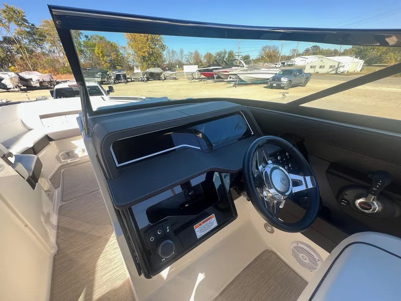 Slide: The Image of 2018 Sea Ray 280 SLX boat cockpit with steering wheel and dashboard controls. - 17